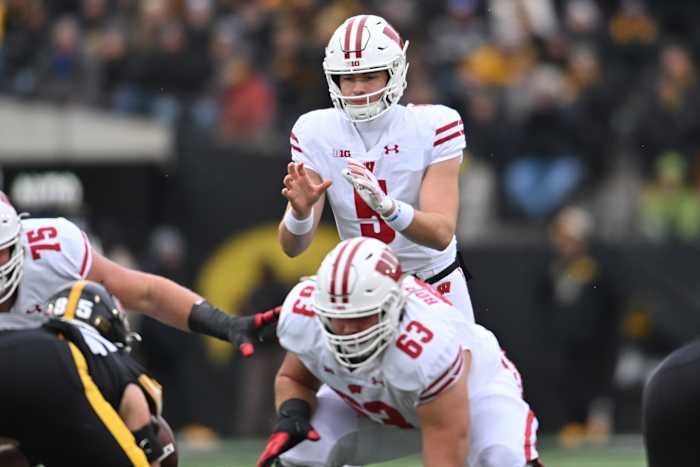 Wisconsin quarterback Graham Mertz receiving the snap out of shotgun at Iowa